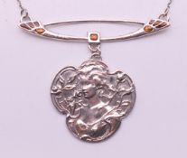 A silver Art Nouveau-style pendant necklace. The pendant 4 cm high.