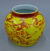 A Chinese orange ground porcelain vase decorated with yellow dragons. 11.5 cm high.