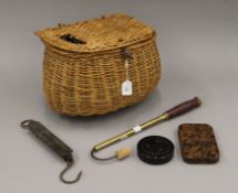 An old wicker fishing creel with a Salters 'Pocket Balance' brass scale, a Hardy Brothers gaff,