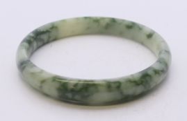 A two-tone jade bangle. 6 cm inner diameter.
