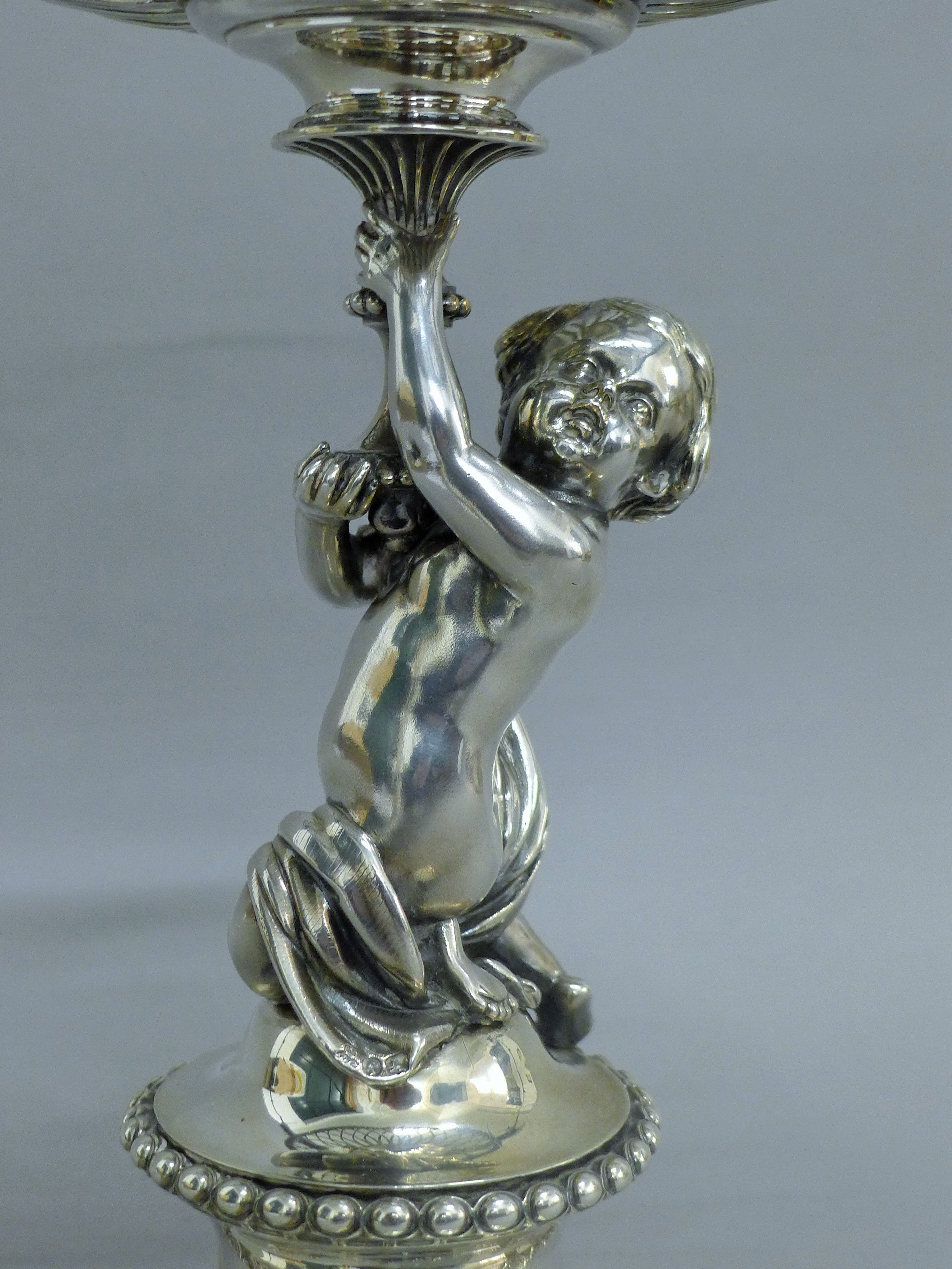 A Victorian silver centrepiece, the stem formed as a putto holding a pierced basket, - Image 3 of 10