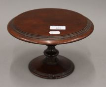 A Victorian miniature mahogany centre table. 22 cm diameter.