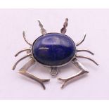 A silver and lapiz crab form brooch. 3 cm wide.