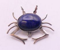 A silver and lapiz crab form brooch. 3 cm wide.