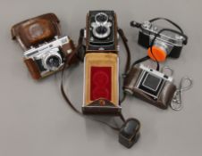 Four various cameras, a Kodak Retina IIa, IIIS, Voigtlander Vitessa T and Yashica 635.