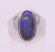 An 18 k white gold and opal ring. Ring size O/P.