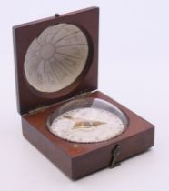An 18th/19th century mahogany domed pocket compass, the dial inscribed Charles Nephew & Co Calcutta.