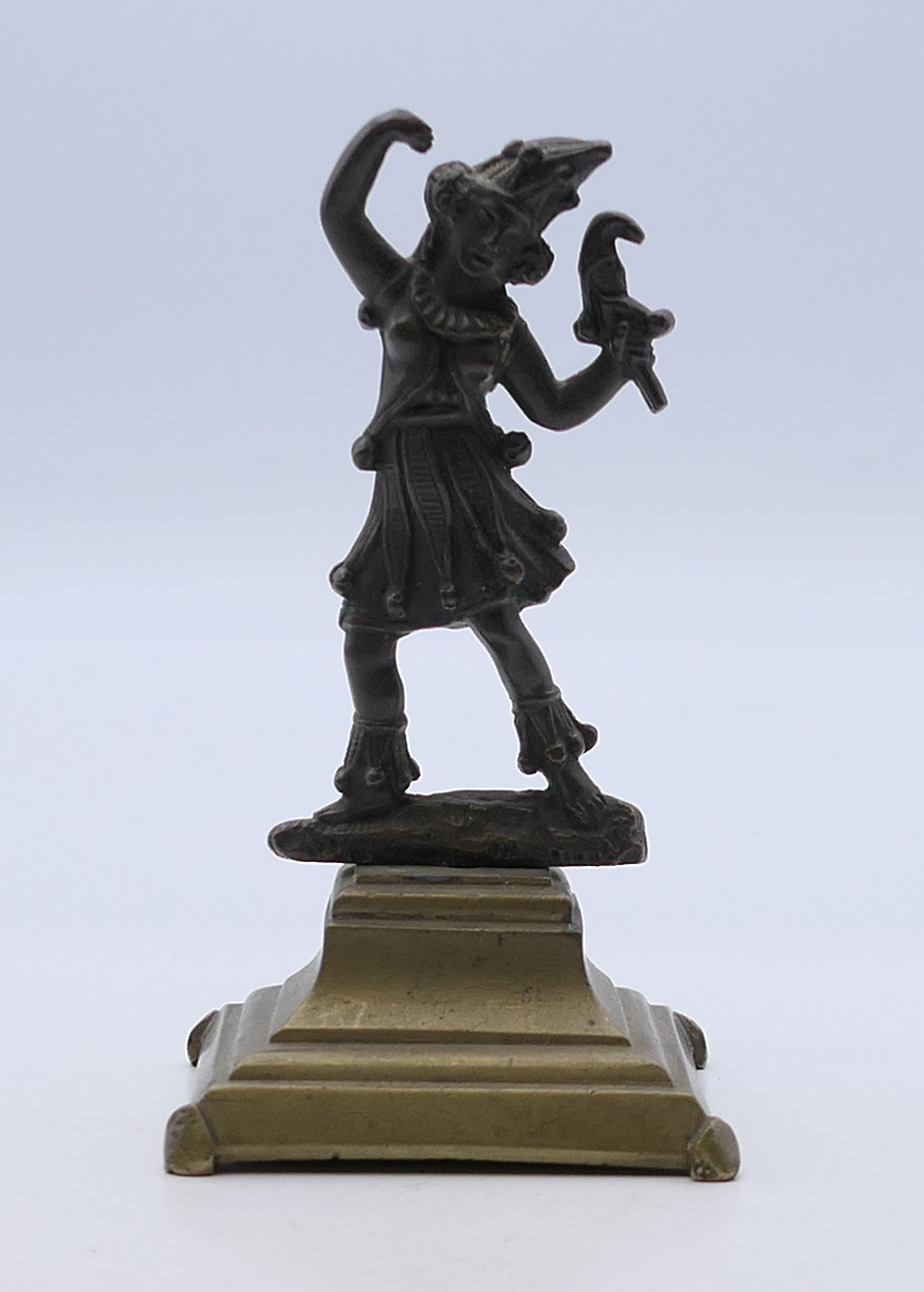 A 19th century bronze model of a jester mounted on a brass base. 10 cm high.