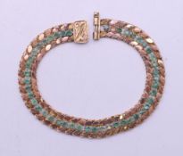 A 15 ct gold and emerald bracelet. 19 cm long. 11.5 grammes total weight.