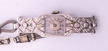 A circa 1930's ladies platinum and diamond wristwatch on metal bracelet. 1.3 cm wide.