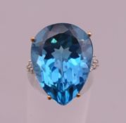 A 9 ct gold blue stone and diamond set ring. Ring size N/O. 6.9 grammes total weight.