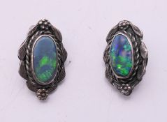 A pair of silver and opal clip-on earrings. 2 cm high.