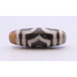 A gold inlaid dzi bead. 35.5 mm long.