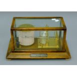 A Short & Mason of London 1950's oak barograph with applied presentation plaque 'Presented by