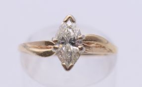 An unmarked gold single stone marquise diamond ring. Ring size K/L.