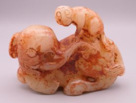 A russet jade model of an elephant and monkey. 8.5 cm long.