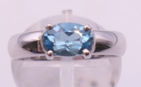 A platinum and aquamarine or topaz ring. Ring size K/L.