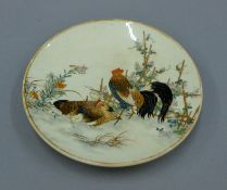 A Satsuma dish decorated with chickens. 12.5 cm diameter.