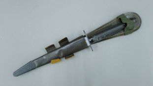 A Fairbairn Sykes commando dagger in sheath. 30.5 cm long.