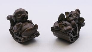 A pair of bronze models of pigs on rocking chairs. The largest 4.5 cm high.