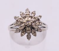 A 14 k white gold diamond cluster ring. Ring size M/N.