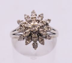 A 14 k white gold diamond cluster ring. Ring size M/N.