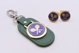 A pair of Rolex Wimbledon cufflinks and key ring with certificate. The former each 1.75 cm diameter.