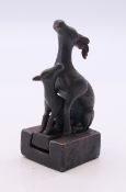 A small bronze double deer seal. 5 cm high.