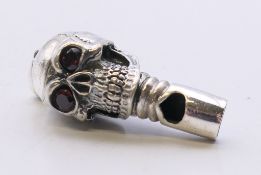 A silver skull whistle. 3.5 cm high.