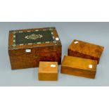 An inlaid burr wood box containing various items including a thermometer, a calendar,