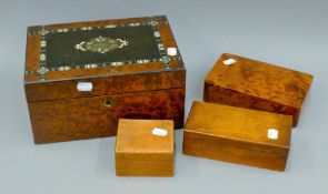 An inlaid burr wood box containing various items including a thermometer, a calendar,