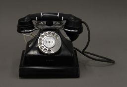 A vintage black telephone. 20 cm wide.