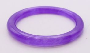 A lavender jade bangle. Approximately 6 cm inner diameter.