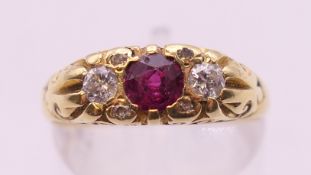 An 18 ct gold diamond and ruby ring. Ring size N/O. 5 grammes total weight.