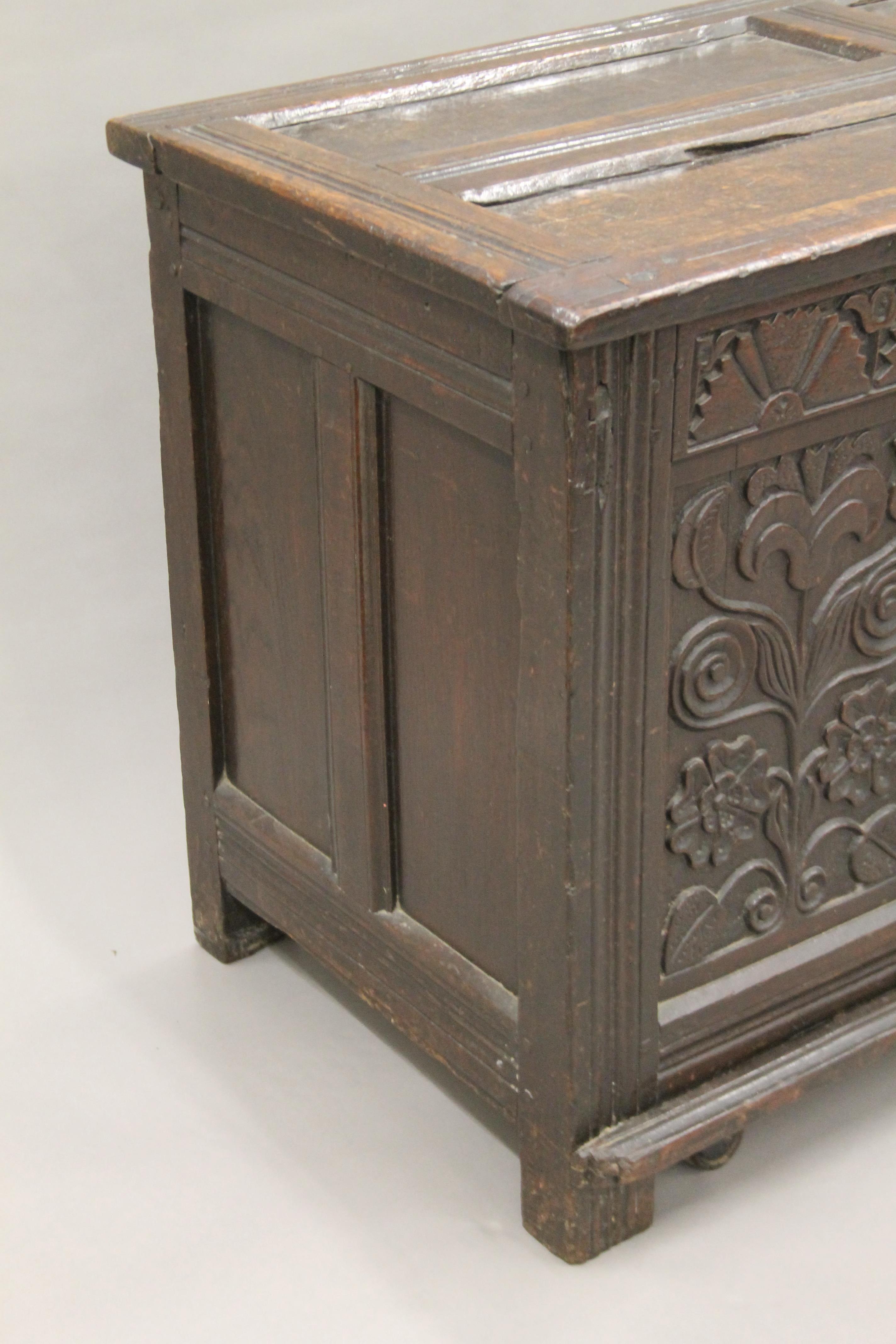 An 18th century carved oak coffer. 123 cm long. - Image 3 of 6