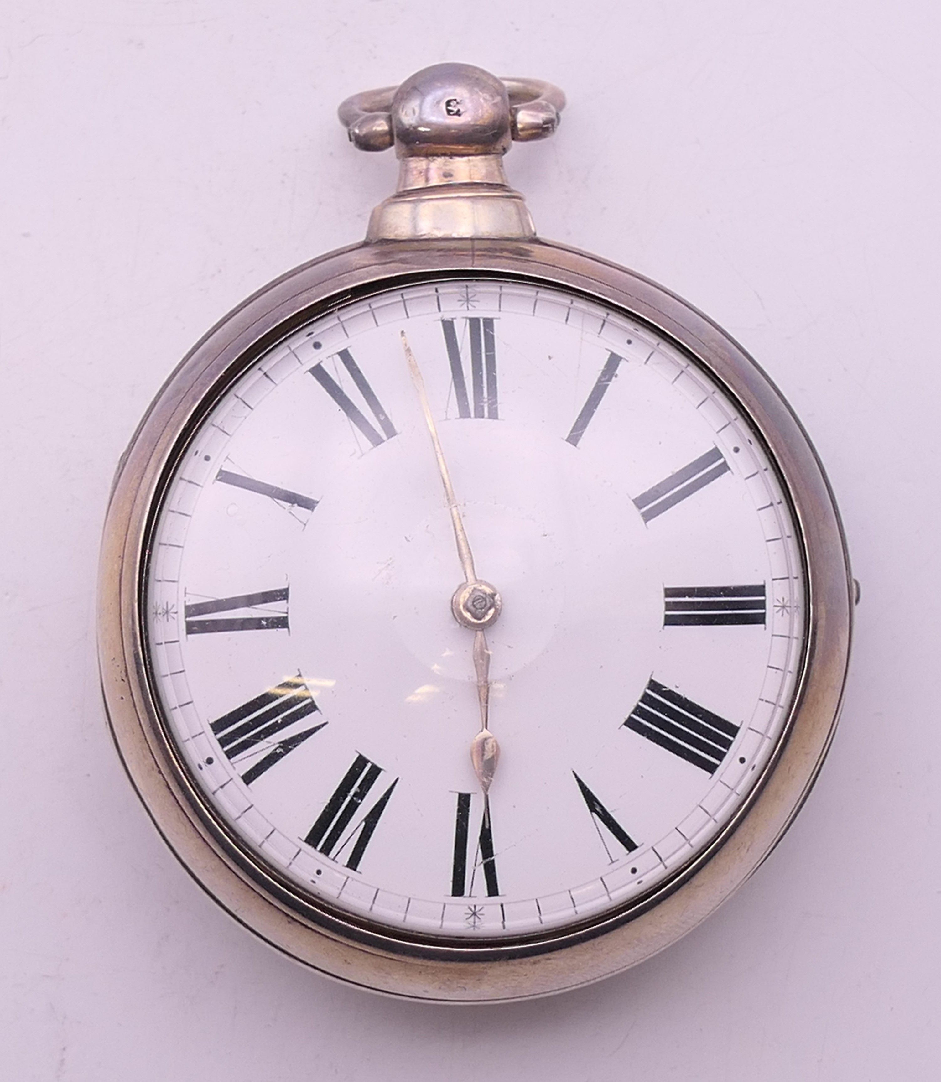 A silver pair cased pocket watch. 5.5 cm diameter.