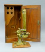 A large John Browning brass binocular microscope in mahogany case. The case 48.5 cm high.