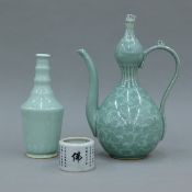 A celadon ewer, a Chinese celadon bottle and a Chinese crackle glaze pot. The former 31.5 cm high.