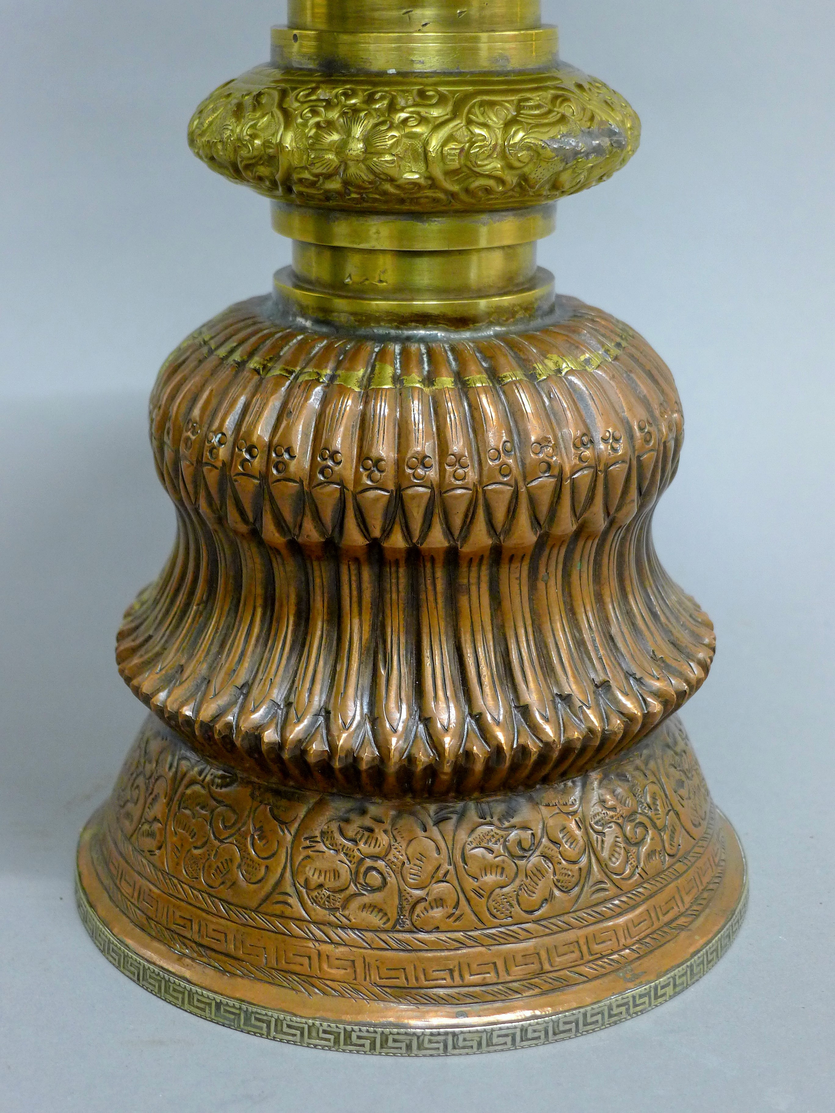 A late 19th century large Tibetan copper and brass butter lamp with silver base rim. - Image 4 of 5