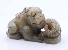 A jade dog of fo and fish carving. 6 cm long.