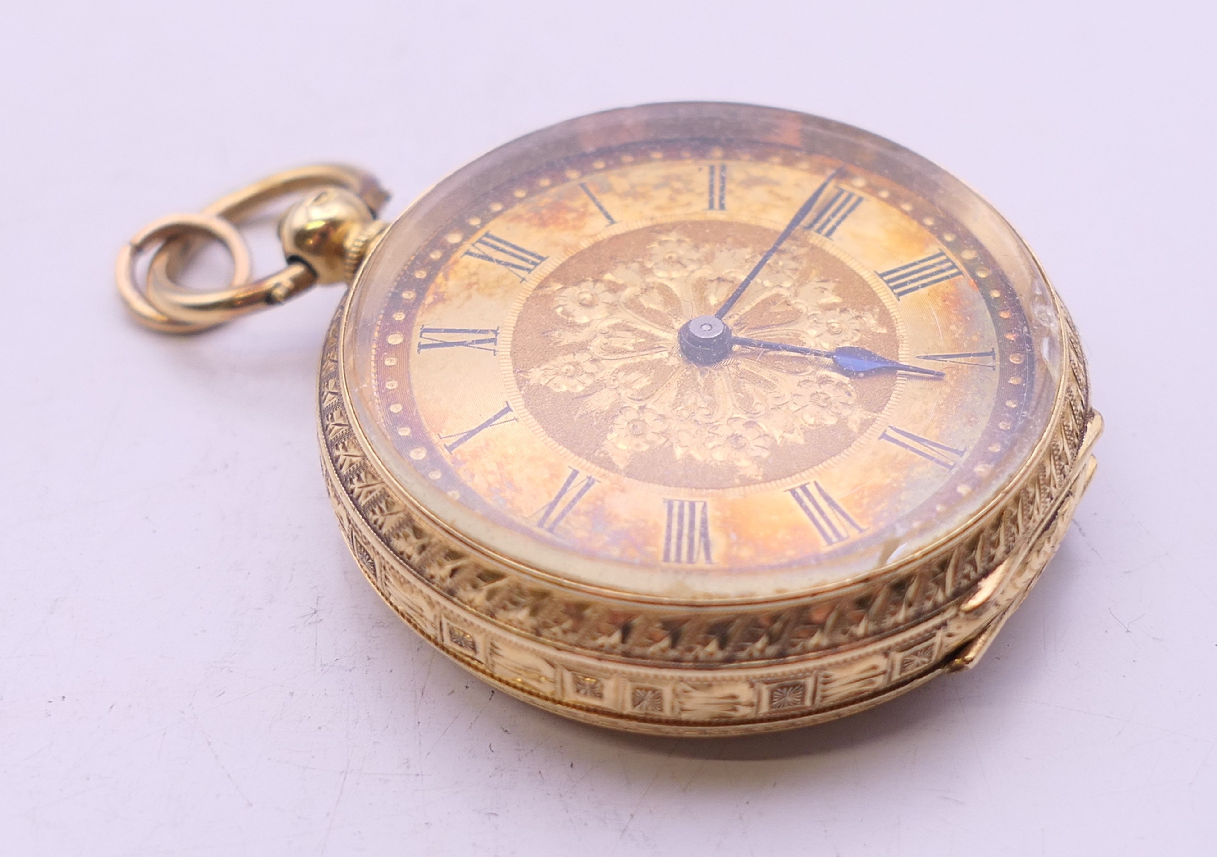 An 18 K gold cased open face pocket watch. 3.5 cm diameter. 42.5 grammes total weight. - Image 2 of 7