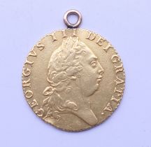 A 1792 Spade Guinea. 2.5 cm diameter. 8.5 grammes. (with added suspension loop).
