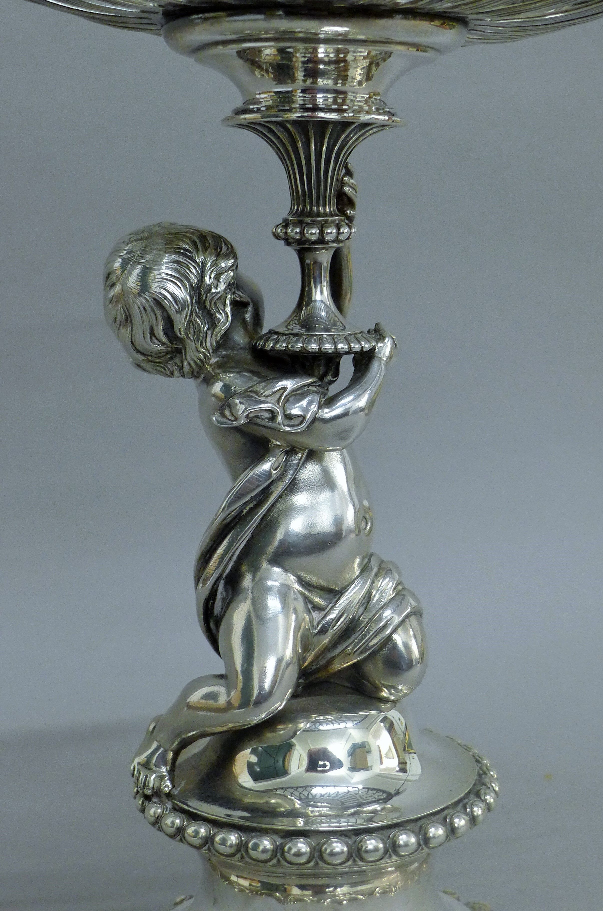 A Victorian silver centrepiece, the stem formed as a putto holding a pierced basket, - Image 5 of 10