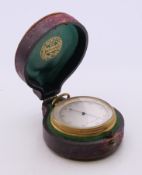 A Victorian cased compensated pocket barometer by Dixey of London. 4.5 cm diameter.