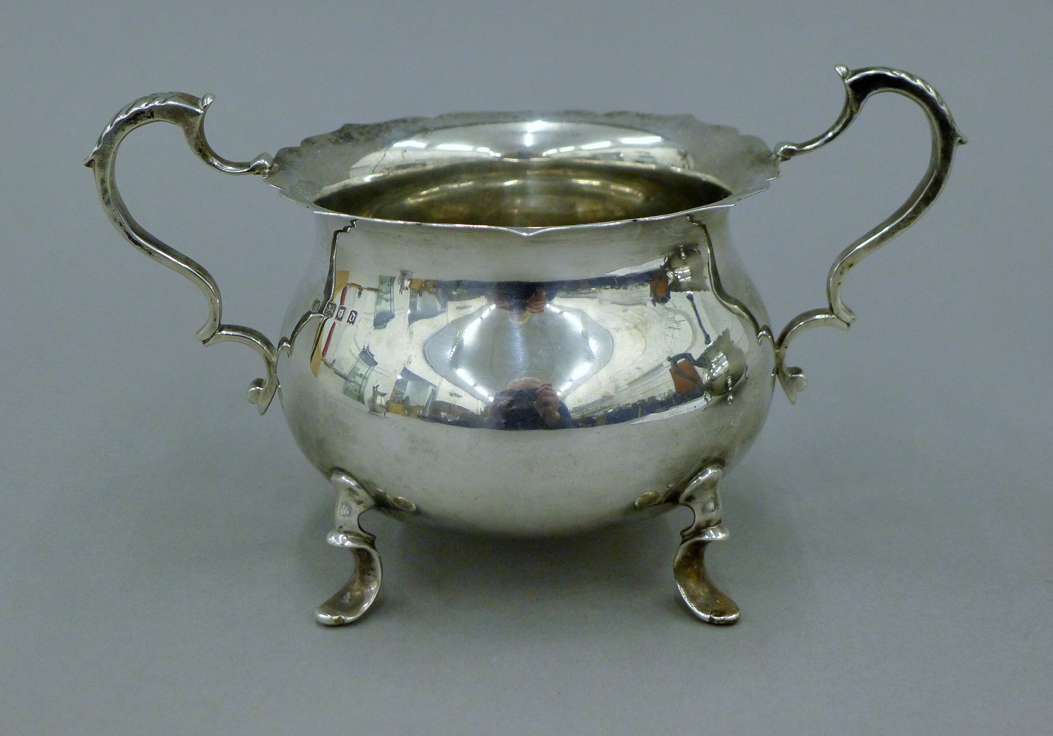 A three-piece silver tea set. The teapot 27 cm long. 34.5 troy ounces total weight. - Image 8 of 13