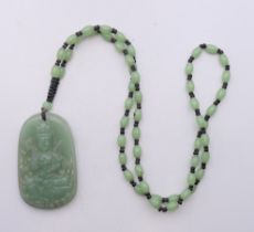 A string of jade beads with a pendant. The beads 62 cm long.