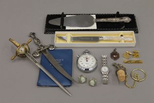 A box of miscellaneous items including paper knives, coins, cufflinks etc.