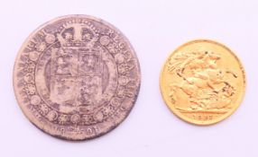 A 1911 gold sovereign and a Victorian 1891 silver coin.