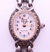 A ladies wristwatch with silver and amethyst bracelet strap. 18 cm long.
