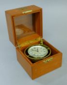A cased Waltham chronometer. 12.5 cm wide.
